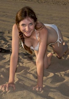 Redhead teen Patience Dolder teases on the beach