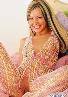 Aaliyah Love toys her tight pussy with a glass dildo in her rainbow fishnet