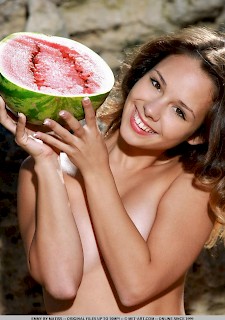 hot babe Emmy playfully poses with a watermelon on her sweet body outdoor
