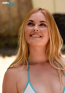 pretty babe Bailey Rayne strips off bikini top on beach
